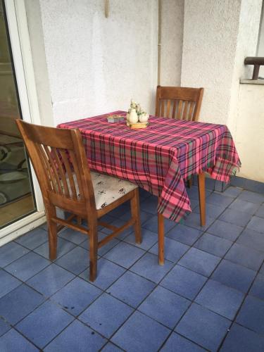 a table and two chairs with a platter of fruit on it at Ohrid Strict Center Apartment in Ohrid