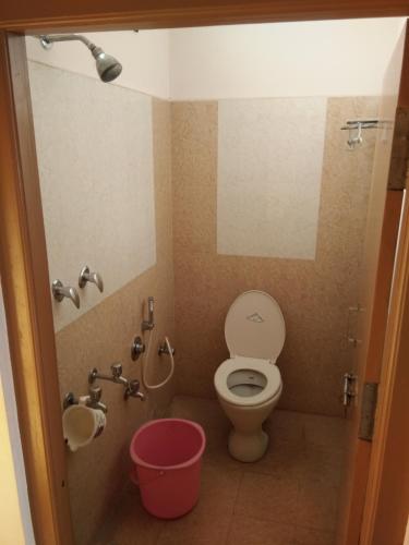 a bathroom with a toilet and a sink at COMFORT INN in Nāmakkal
