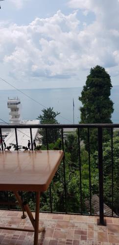 a balcony with a table and a view of the ocean at Yellow House - Vaja in Sarpi