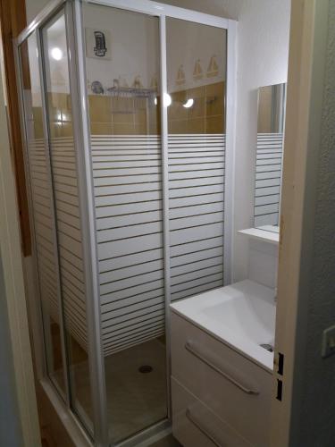 La salle de bains est pourvue d'une douche à l'italienne et d'une armoire blanche. dans l'établissement studio Cap D'adge, au Cap d'Agde