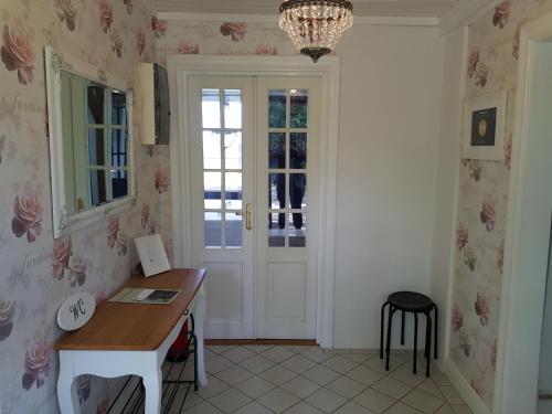 a room with a desk and a door with a window at Bröttorp in Fjugesta