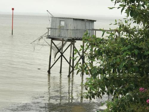 a shack sitting in the middle of the water at Les Trémières in Le Thou