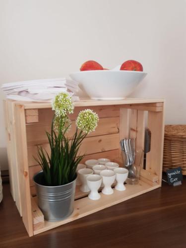 a wooden shelf with white vases and a plant at Weltmann`s Hotel & Restaurant in Ennepetal