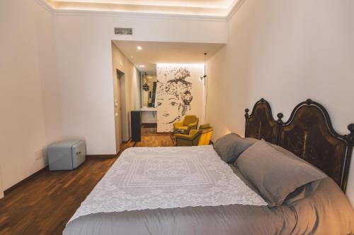 a bedroom with a large bed in a room at Suites of the Royal Council in Siracusa