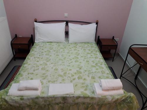 a bedroom with a large bed with two night stands at Monika Lefkada in Tsoukaladhes