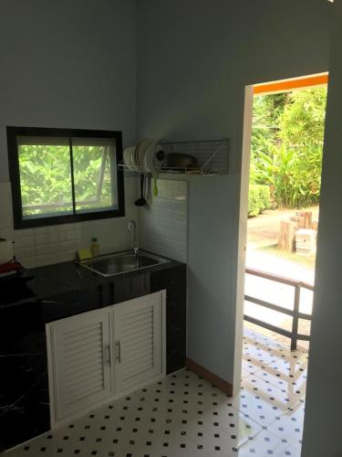 a kitchen with a sink and a window and a counter at Fine Times Resort in Ko Chang