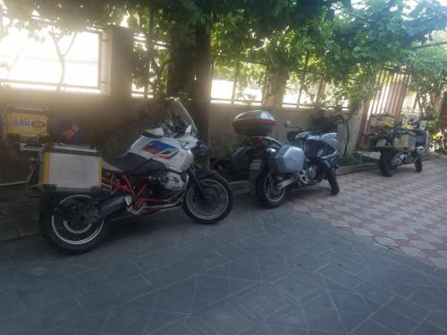 a couple of motorcycles parked next to a building at Karine B&B in Yeghegnadzor