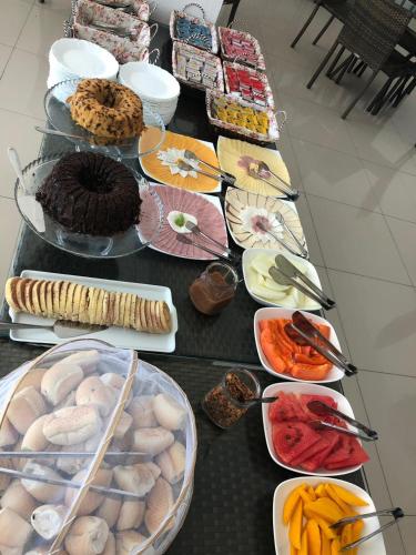 a table topped with lots of different types of food at Muro Alto Condomínio Clube in Cupe
