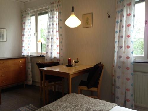 a bedroom with a table and a bed and a window at Storliens Fjällgård in Storlien