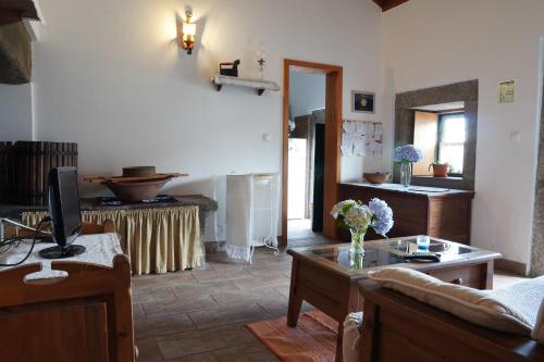 a living room with a couch and a table at Casa do ti' Marrão in Praia da Vitória