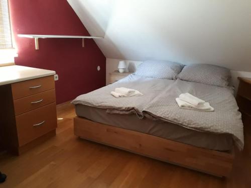 a bedroom with a bed with two towels on it at Apartma Dolomiti in Ljubljana