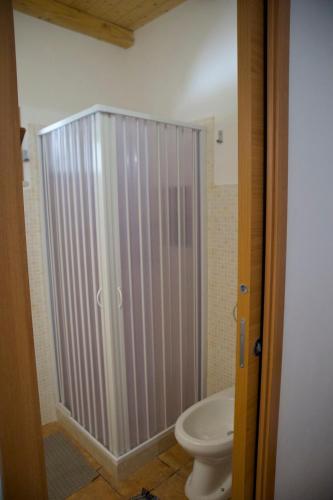 a bathroom with a toilet and a shower stall at Casa Vacanza e Camera Fabiola in Castellammare del Golfo