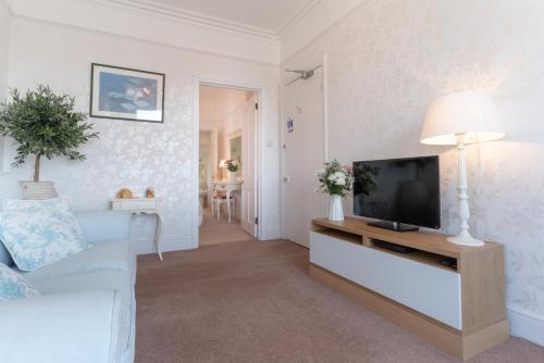 a living room with a tv and a couch at Barnes Fell Apartments in Ambleside