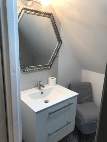 a bathroom with a white sink and a mirror at Apartament Roti Solina in Solina