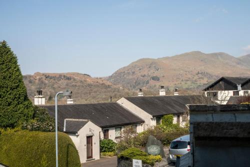 a group of houses with mountains in the background at Barnes Fell Apartments in Ambleside