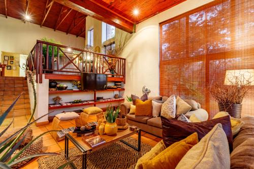 a living room with a couch and a table at Ulwazi Rock Lodge in Hazyview