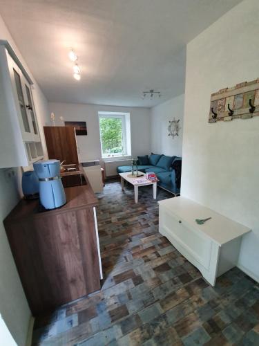 a living room with a couch and a table at Marijanas Ferienhof 2, Urlaub mit viel Platz zwischen Dornumersiel und Bensersiel, gehört zum Café Kunterbunt in Holtgast