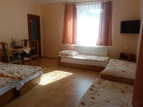 Postel nebo postele na pokoji v ubytování Rodzinna Przystań