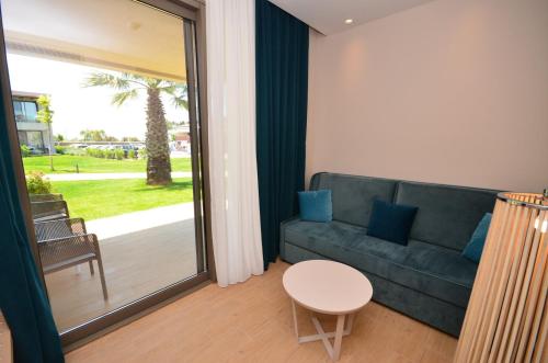 a living room with a couch and a table at Almyros Beach in Acharavi