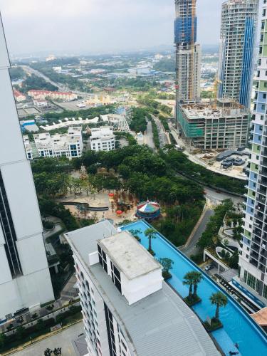 a view of a city from a building with a pool at D'Gunduls Homestay STUDIO by DGH I-CITY in Shah Alam