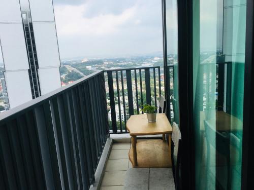 a balcony with a table and a view of the city at D'Gunduls Homestay STUDIO by DGH I-CITY in Shah Alam