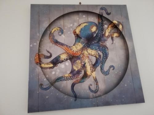 a painting of an octopus on a wall at B&B Vie En Rose in Porto Cesareo