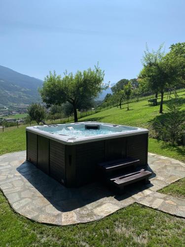 a hot tub in the middle of a field at L'armonia della natura in Aosta