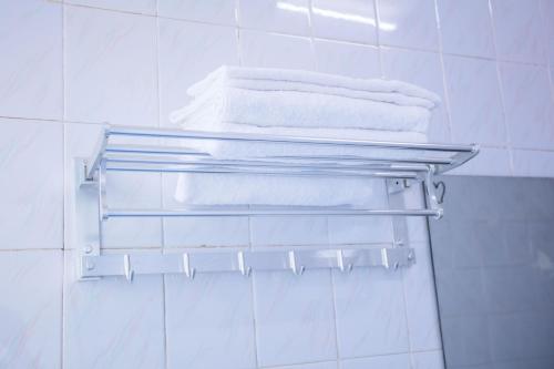 a towel rack in a bathroom with towels at Murphy Youth Hostel Guilin桂林北站莫非青年旅舍 in Guilin