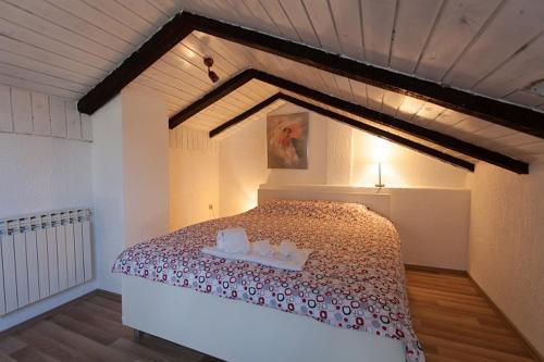 a bedroom with a large bed in a room at Apartman M&S in Njivice
