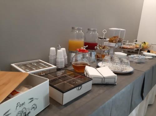 a table with a buffet of food and drinks at Vianova Affittacamere in Giurdignano
