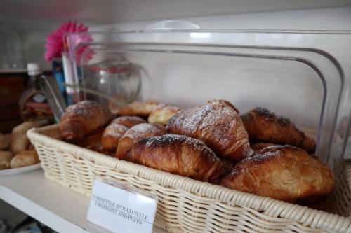 a basket of croissants and other pastries in a bakery at B&B Sorrento Central in Sorrento