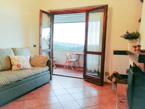 a living room with a couch and a sliding glass door at Casa Alice in Camigliatello Silano