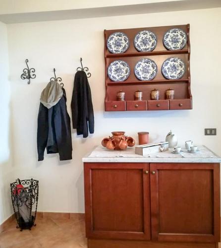 a kitchen with a counter with plates on a wall at Casa Alice in Camigliatello Silano
