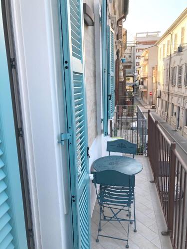 a small balcony with two chairs and a table at B&B LOFT EDEL BEACH in Civitanova Marche