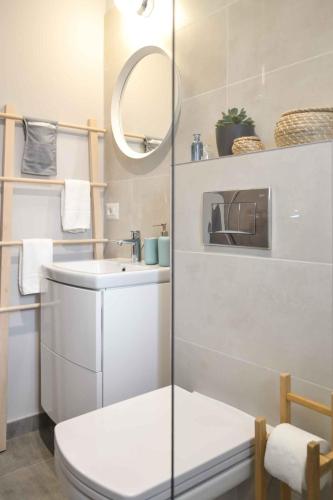 a bathroom with a toilet and a sink and a mirror at Vila White Tulip in Alba Iulia