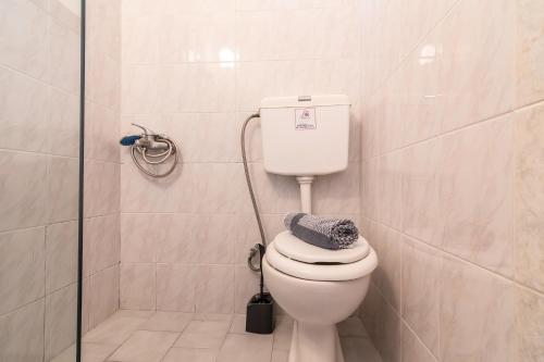 a bathroom with a toilet with a towel on it at Girogiali beach hotel - Adults only in Stalos