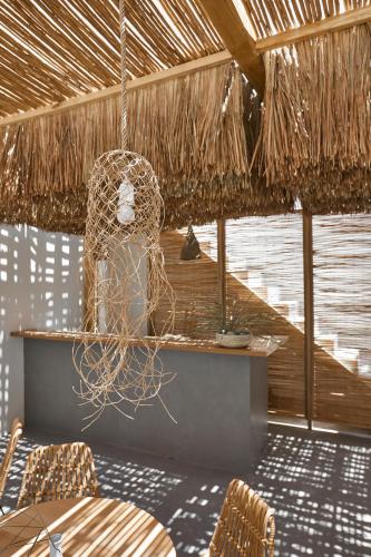 a room with a table and chairs and a net at Arco Solium Suites in Adamas
