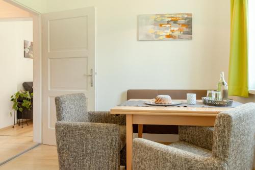 a dining room with a table and two chairs at Haus Elisabeth in Seeboden