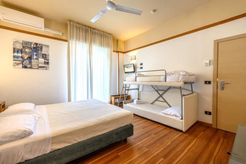 a bedroom with a bed and a bunk bed at Hotel St Gregory Park in Rimini