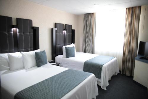 Ένα ή περισσότερα κρεβάτια σε δωμάτιο στο Best Western Real Tula Express