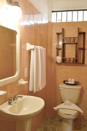 a bathroom with a toilet and a sink at Hotel Posada De Roger - Near Los Muertos Beach in Puerto Vallarta