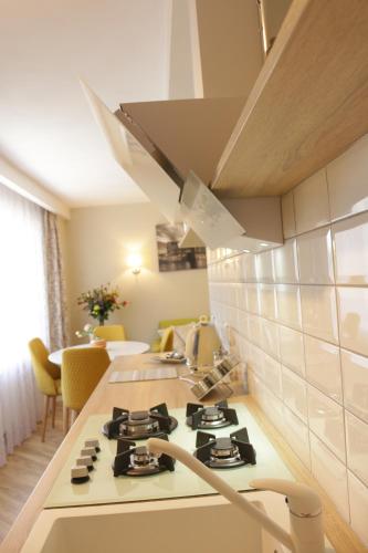 a kitchen with a stove top oven in a room at TIP TOP in Šiauliai