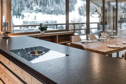 a dining room with a table with glasses on it at Chalet Ourtls Pärg in Solda