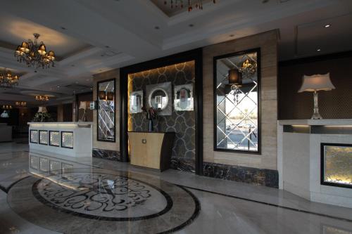 a lobby with a reception desk and windows at Boudl Kuwait Al Fahahil in Kuwait
