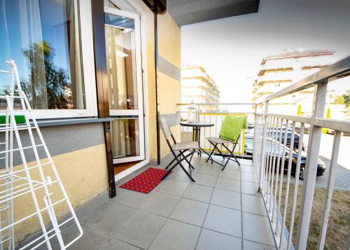 a balcony with chairs and a table on a balcony at Apartamenty Tercet, Apartament Sonata in Ustka