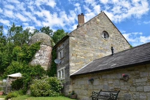 an old stone building with a bench in front of it at Little Turret in St. Leonards