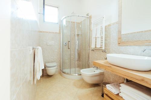 a bathroom with a sink and a toilet and a shower at Chez Lia - Private garden and tub, sea view close to Villa Eva and Cimbrone, Ravello in Ravello