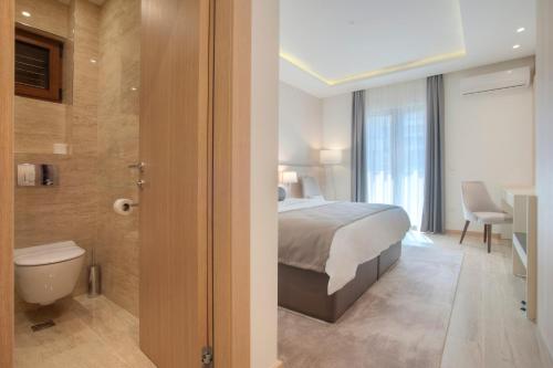 sypialnia z łóżkiem oraz łazienka z toaletą w obiekcie Hotel Vela w Budvie