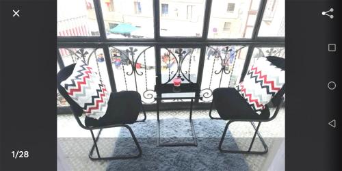 two chairs sitting in front of a window at Mirador de Cristal-Centro-parking - 2 habitaciones-2 baños in Soria