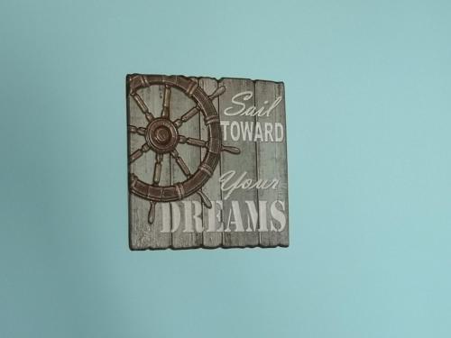 a sign with a wheel that says said sweet toland above dreams at Apartments Sandra in Lopar